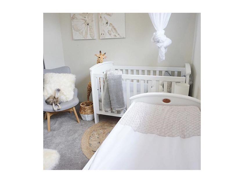 Baby nursery with a crib and change mat with cover