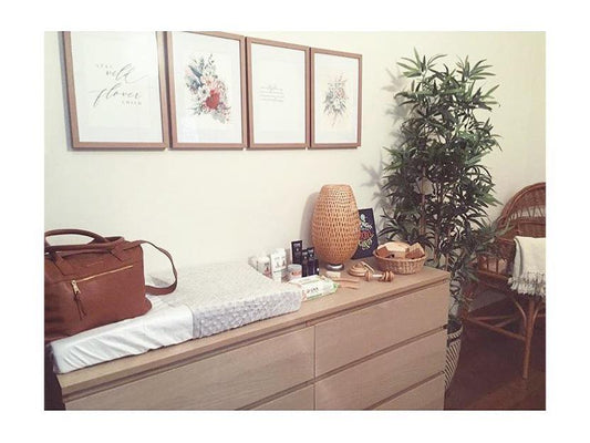 Baby change mat cover and baby change pad on a wooden counter